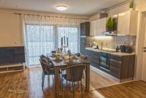 a kitchen with a dining room table with chairs at Urbana Villa Four season in Zagreb