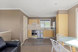 a living room with a couch and a table at Aqualuna Beach Resort in Coffs Harbour