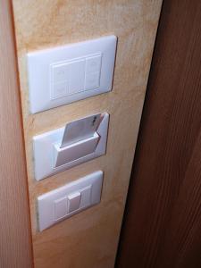 two electrical outlets on a wooden door at Affittacamere Matteo in Verona