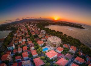 an aerial view of a city with the sunset at The LODGE Hotel in Tsarevo