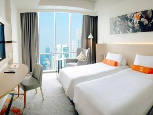 Katil atau katil-katil dalam bilik di HARRIS Suites fx Sudirman