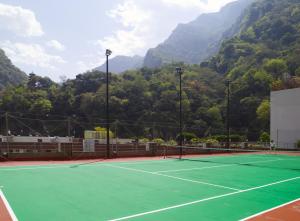 a tennis court with a tennis racket on it at Silks Place Taroko Hotel in Fushi