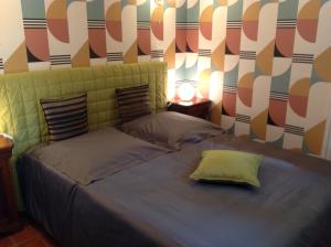 a bedroom with a bed with a headboard at A l'ombre du cedre in Hyères