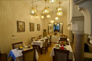 a restaurant with tables and chairs and chandeliers at La Claire Fontaine in Marrakesh