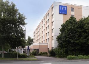 a large building with a sign on the side of it at Tryp by Wyndham Wuppertal in Wuppertal