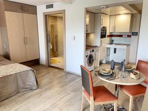 a small room with a table and a kitchen at ZENAO MONTREUIL- Croix de Chavaux in Montreuil +33 photos