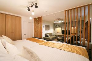 a hotel room with two beds and a desk at Kubotei in Sapporo