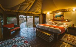 Una cama o camas en una habitación de Jamtara Wilderness Camp - Pench National Park