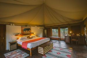 Een bed of bedden in een kamer bij Jamtara Wilderness Camp - Pench National Park