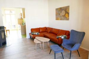 a living room with a couch and a table and chairs at Villa Inga & Anne in Ahlbeck