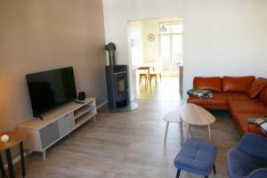 a living room with a couch and a flat screen tv at Villa Inga & Anne in Ahlbeck