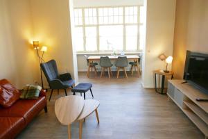 a living room with a couch and a table with chairs at Villa Inga & Anne in Ahlbeck