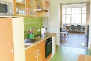 a kitchen with a sink and a stove top oven at Villa Inga & Anne in Ahlbeck +30 photos