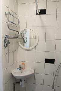a bathroom with a sink and a mirror at Jūros takas in Juodkrantė +59 photos