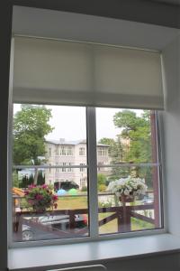 a window with a view of a building at Jūros takas in Juodkrantė