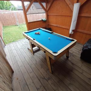 a pool table sitting on a deck in a shed at Willa , Cosy house in Inverness in Inverness