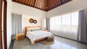 a bedroom with a bed and a large window at Villa Dew Canggu in Kerobokan +29 photos
