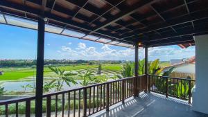a balcony with a view of a rice field at Villa Dew Canggu in Kerobokan