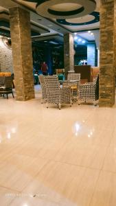 a lobby with chairs and tables in a building at شقق وشليهات رشيد علي ضفاف بحيره قارون in Shakshuk
