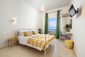 a bedroom with a bed and a view of the ocean at Batelo - Adults Only in Benitses