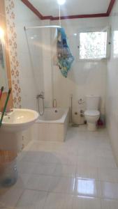 a bathroom with a tub and a toilet and a sink at الساحل الشمالي in Borg El Arab