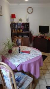 a table with a purple table cloth on it at Haus am Bach in Freiburg im Breisgau