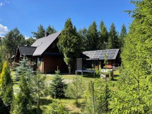 a house with solar panels on the roof at Ostoja Kaczórki in Kaczórki