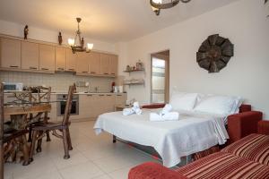 a bedroom with a bed with towels on it at Villa Linda in Tolo