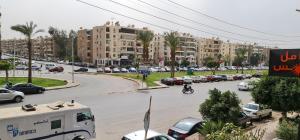 a busy city street with cars parked on the road at Comfy 2 Bedrooms Apartment in Cairo 98-5 in Cairo