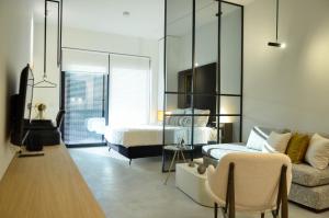 a living room with a bed and a couch at Allofts in Kalamata