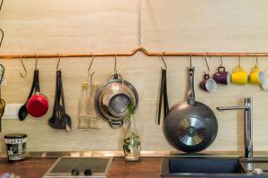 a kitchen with utensils hanging on a wall at Apartments Eos & Vespera in Dubrovnik