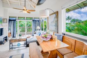 a living room with a table and a couch at Paniolo #202A in Princeville