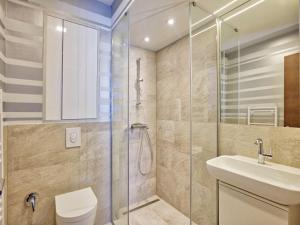 a bathroom with a shower and a toilet and a sink at Sarajevo Waves Aparthotel in Sarajevo +163 photos