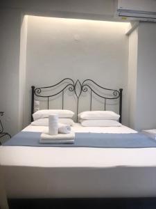 a bed with white sheets and towels on it at Nikiti, four seasons house in Nikiti