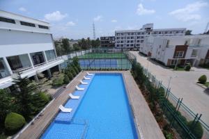 an overhead view of a pool with two tennis courts at VRR Astoria Hotel & Convention Center in Bangalore