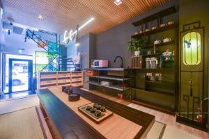 a living room with a bench and a staircase at Min-sheng Art homestay in Tainan