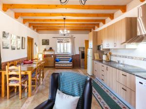 a kitchen and dining room with a table and chairs at Cortijo la erilla in Dúrcal