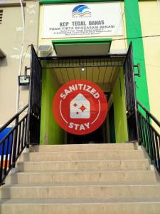 a set of stairs with a sign on a building at SPOT ON 91402 Home'59 Tegal Danas in Bekasi