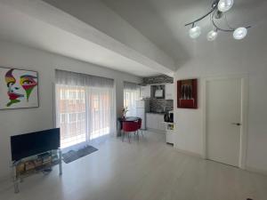 トレビエハにあるHomely Apartments La Gaviotaの広いリビングルーム(テレビ、テーブル付)