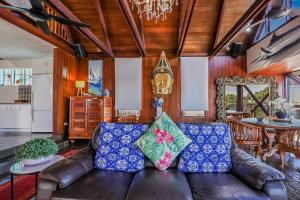 a living room with a leather couch and a table at 1770 Sovereign Lodge Retreat in Seventeen Seventy