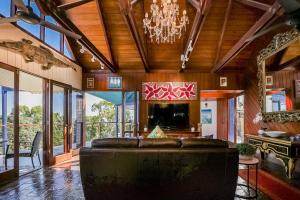 a large living room with a couch and a chandelier at 1770 Sovereign Lodge Retreat in Seventeen Seventy