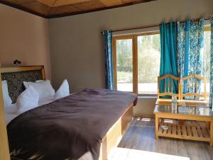 a bedroom with a large bed and a window at Rimo in Nubra