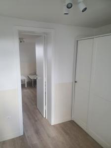 an empty room with white walls and a sliding door at B96 appart 2 bedrooms in Brussels