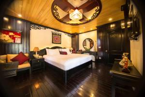 a bedroom with a bed and a large clock on the ceiling at Dragon Legend Cruise in Ha Long