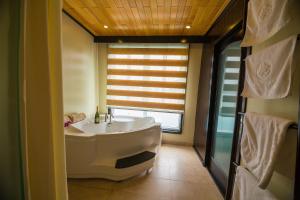 a bathroom with a large tub and a window at Dragon Legend Cruise in Ha Long