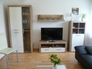 sala de estar con TV y sofá en Ferienwohnung Kutscherhof Bartels, en Bispingen