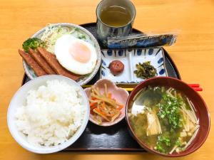 a tray of food with rice and a plate of food at Housei in Zamami