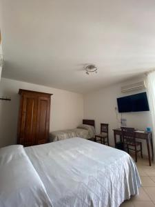 a bedroom with a large white bed and a desk at L’attico Piazza Sant’Oronzo in Lecce