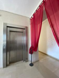 a room with a door with a red curtain at L’attico Piazza Sant’Oronzo in Lecce +6 photos