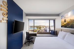 a hotel room with a bed and a large window at Travelodge Harbourfront Singapore in Singapore